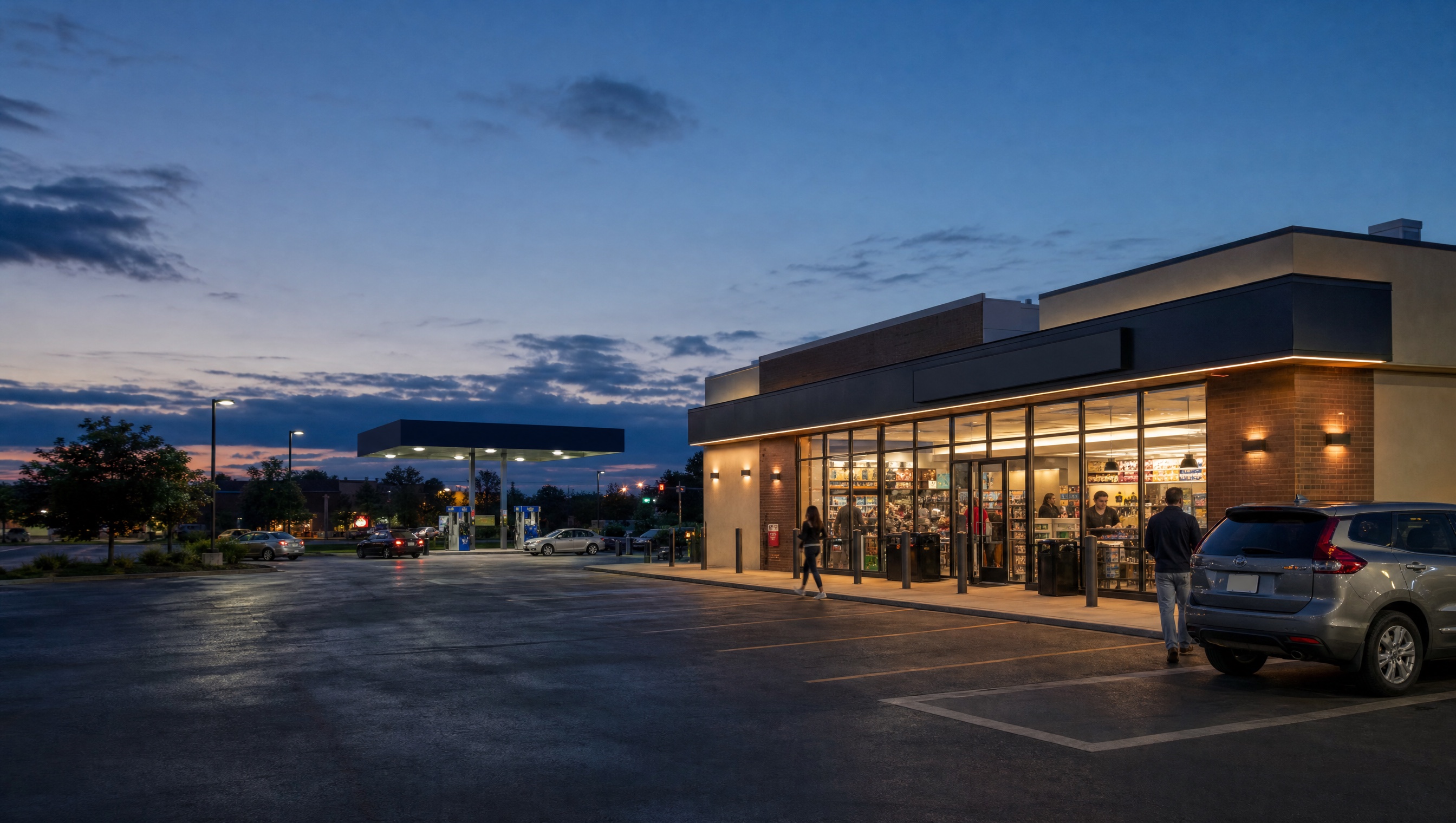 Customers arrive at an unbranded convenience store and fuel site at dusk.